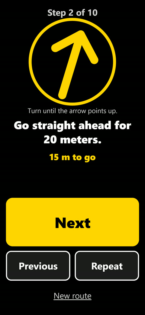 Voice guidance screen: large yellow compass arrow, instruction “Go straight ahead for 20 meters”, Next button